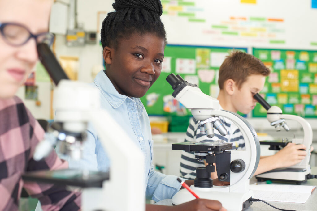 Young scientist with microscope